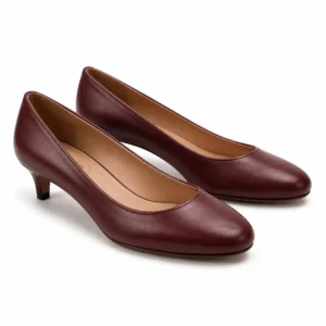 Private label round toe leather pump low heel in burgundy, shown in a front three-quarter hero view for wholesale and B2B footwear sourcing.