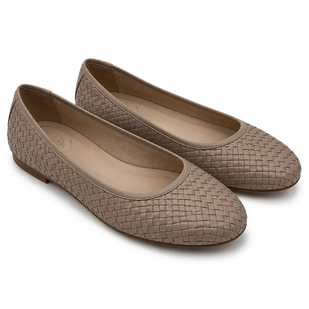 Private label woven leather ballet flat in a soft taupe studio presentation, showcasing the woven leather design for brands, retailers, wholesalers, importers and footwear sourcing teams.