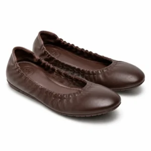 Private label elasticated foldable ballet flat in a chocolate brown studio presentation, showing the flexible ballet-flat silhouette for brands, retailers, wholesalers, importers and footwear sourcing teams.